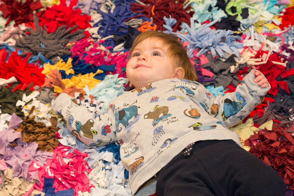 A child on a rag rug
